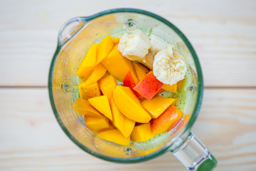 Mixed Spinach with Peach and Banana in a Blender, Smoothie Preparation Process, Top View, Free Space for Text