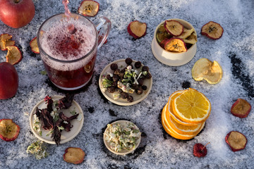 Fototapeta na wymiar New Year or Christmas flat lay top view with Hot red tea with different herb, fresh and dry fruit and berry