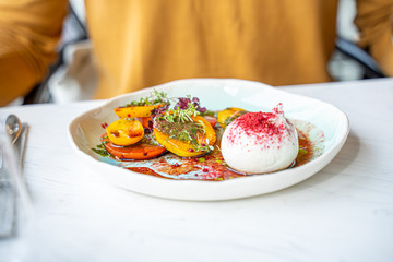 Burrata Cheese Salad with Tomatoes, Basil Leaves, Balsamic Cream Sauce in Luxury Restaurant, Healthy Food Concept