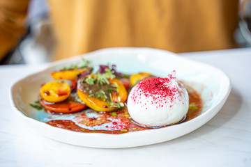 Burrata Cheese Salad with Tomatoes, Basil Leaves, Balsamic Cream Sauce in Luxury Restaurant, Healthy Food Concept