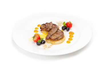 Fried juicy pieces of liver on a piece of pineapple
