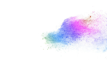 Freeze motion of colorful color powder exploding on white background.  Paint Holi.