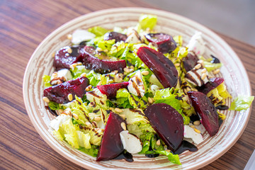 Homemade Healthy Salad with Beetroot, Goat Cheese, Pine Nuts and Balsamic Cream