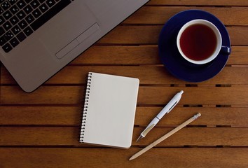 Office desk table with laptop computer, cup and all important properties