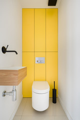 Toilet with yellow wall tiles