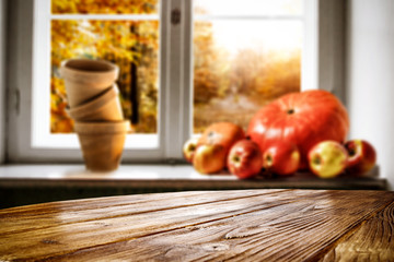 Desk of free space and autumn window background 
