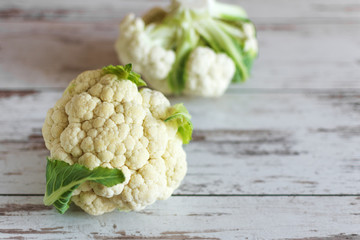 Fresh organic cauliflower on wooden background.