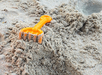 Children's beach toys on sand