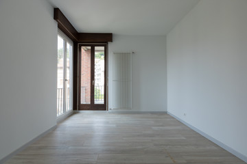 Large empty room with white walls. Parquet