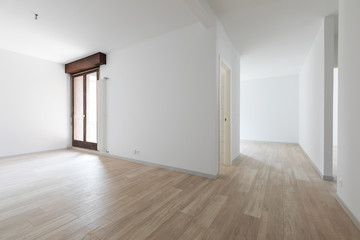 Large empty room with white walls. Parquet