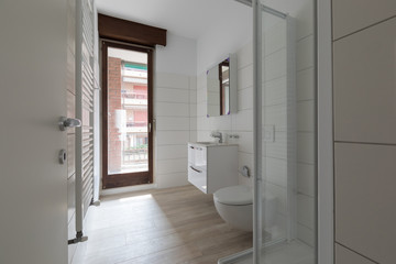 Fototapeta na wymiar Modern renovated bathroom with large tiles and window