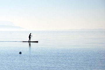 Fototapeta premium Sup ride on a board with a paddle