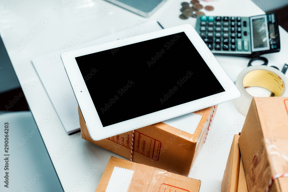 Poster mock up digital tablet with empty screen on small business desk.