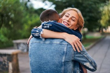 Fototapeta premium Happy meeting of two lovers hugging in the street