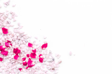 Decoration with stones and flowers frame on white background top view copyspace