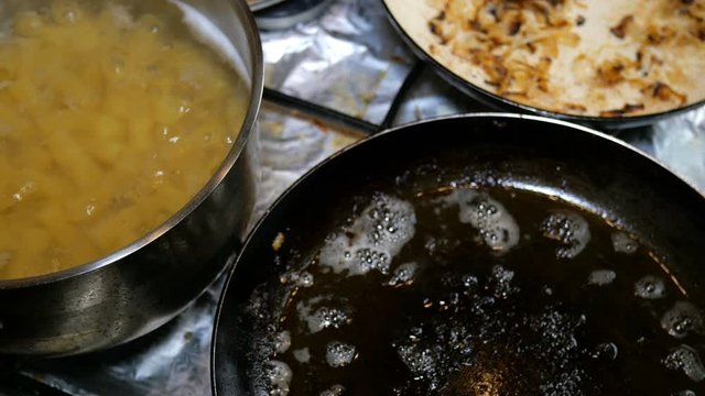 Homemade cooking. Boiled pasta pipe and beef liver or meat steaks is prepared on kitchen stove on home or restaurant kitchen. Close-up.