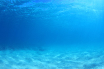 Blue underwater background photo of sea and sand