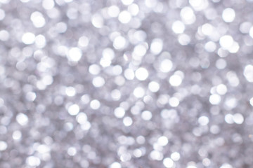 Silver glitter festive background with bokeh lights. Celebration concept for Holidays and anniversary.