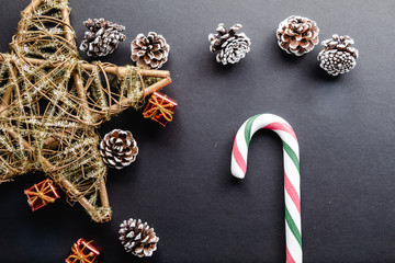 Christmas cane candy on black background and christmas decoration