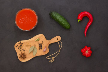 Set of vegetables and spices for making gazpacho tomato soup. Black background