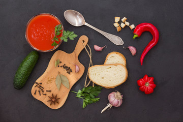 Set of vegetables and spices for making gazpacho tomato soup. Black background.
