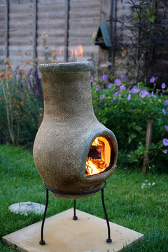 Chiminea On Fire In A Garden