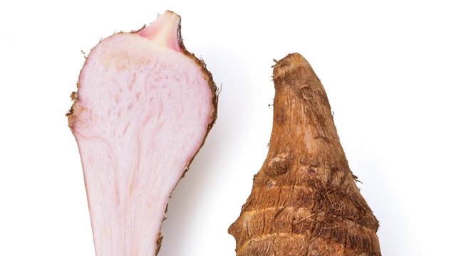 panning fresh taro root isolated on white background. top view