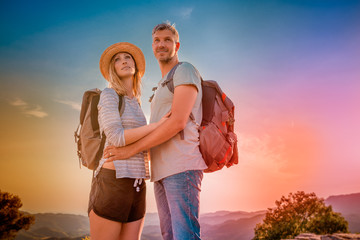 Happy couple with backpacks