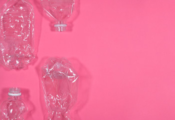 Plastic bottles isolated on pink background. Recycle waste management concept. Plastic Pet Bottles. Copy space, flat lay