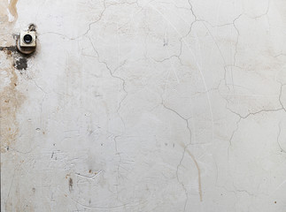Doorbell on old cracked plaster with scratches