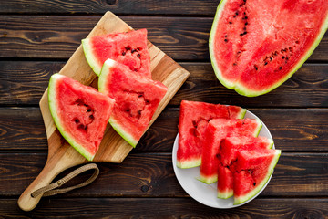 Pieces of watermelon on wooden background top view