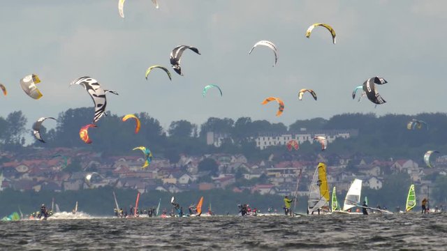 Kitesurfing and Windsurfing Crowd with Multiple Kites in Air Slow Motion 