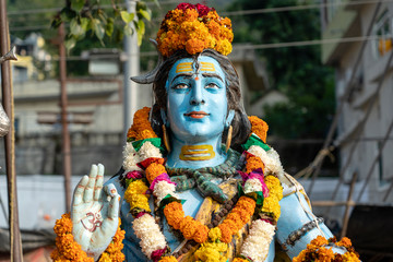Statue Shiva, hindu idol on the ghat near the Ganges river in Rishikesh, India, close up