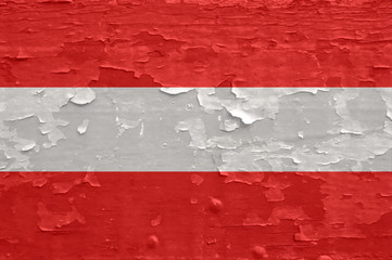 Austria flag on old peeled wooden surface.
