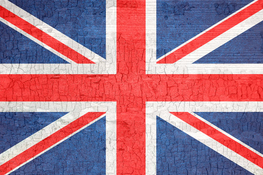 Britain flag on an old painted tattered wooden surface.