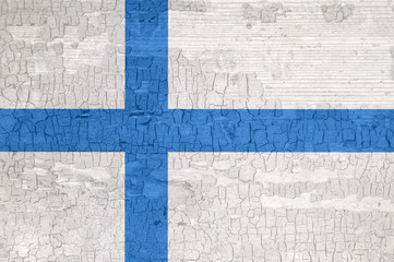 Finland flag on an old painted tattered wooden surface.