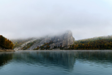 Fog on a lake in Norway in the autumn. Mist Lake mountains