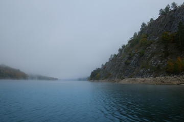 Fog on a lake in Norway in the autumn. Mist Lake mountains