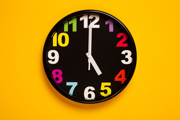 colorful wall clock show five o'clock