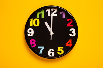 colorful wall clock show eleven o'clock