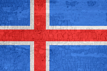 Iceland flag on an old painted tattered wooden surface.