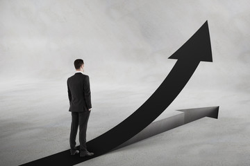 Obraz premium Personal growth and motivation concept with businessman looking at black upward road-arrow.