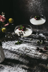 Vegan Coconut Cream Panna Cotta with Cherries on a dark wooden background