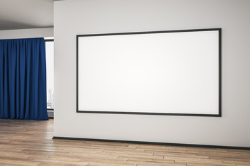 Blank white mock up poster on white wall in spacious empty room with wooden floor and blue curtain.