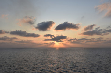 Obraz premium Sunrise over the sea, near Port Said, Egypt. View from the cargo ship transiting Suez Canal. 