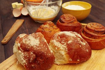 Cooking pastries from natural ingredients to fresh buns on a wooden table.