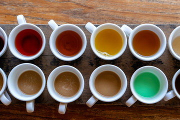 Traditional Balinese coffee and tea after testing on the wooden table in Ubud, island Bali, Indonesia , closeup