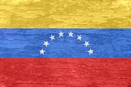 Venezuela flag on an old painted wooden surface.