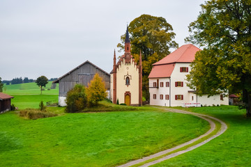 Fototapeta na wymiar church near a house in a village in Germany on the farm