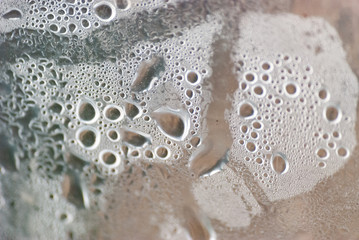 Humidity water drops macro from under the plastic material.